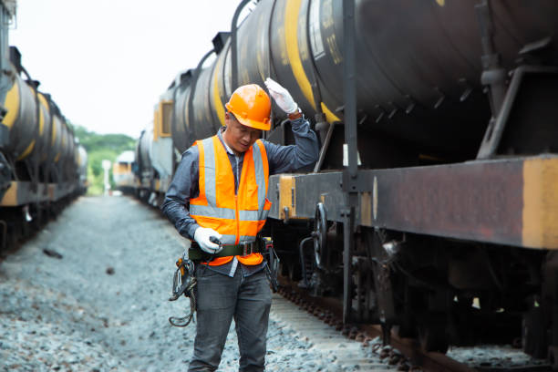 istock asian Inspector Engineering wearing helmet and vest worker unifrom checking railway construction work on rail track. 1328323385
