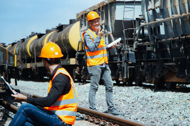 istock asian Inspector Engineering wearing helmet and vest worker unifrom checking railway construction work on rail track. 1328323386