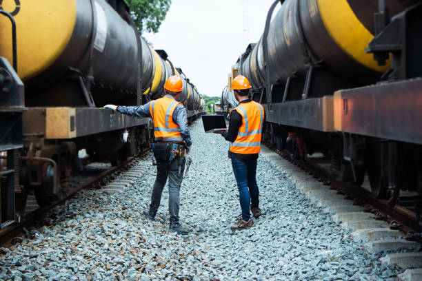 istock asian Inspector Engineering wearing helmet and vest worker unifrom checking railway construction work on rail track. 1328323414