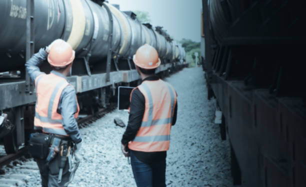 istock asian Inspector Engineering wearing helmet and vest worker unifrom checking railway construction work on rail track. 1328323420