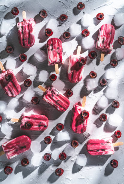 istock Cherry fruit popsicles homemade with yogurt ice cream melting on white 1328323508