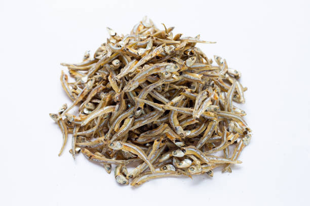 istock Dried anchovy on white background 1328323515
