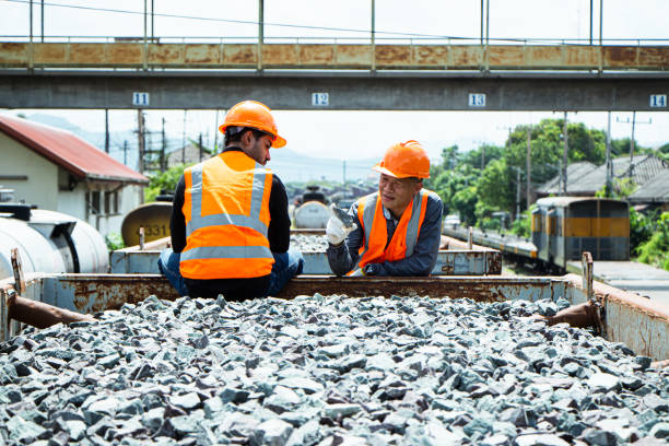 istock asian Inspector Engineering wearing helmet and vest worker unifrom checking railway construction work on rail track. 1328323533
