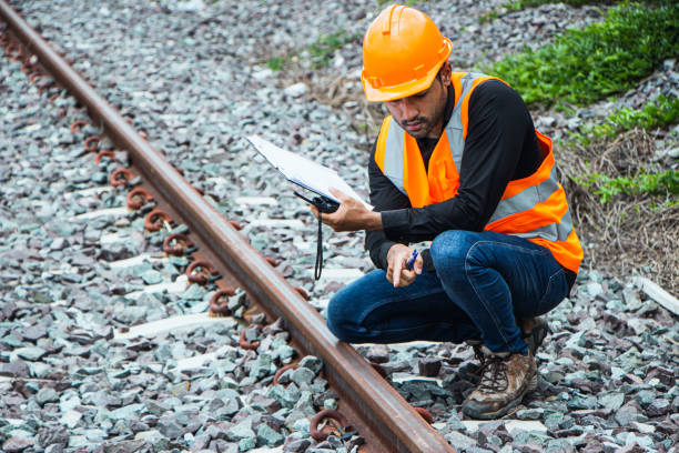 istock asian Inspector Engineering wearing helmet and vest worker unifrom checking railway construction work on rail track. 1328323597