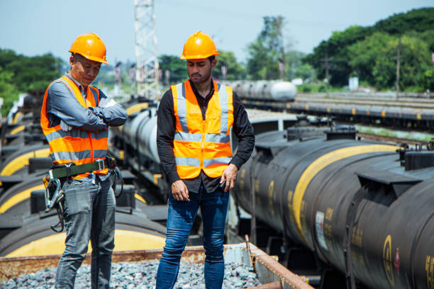 istock asian Inspector Engineering wearing helmet and vest worker unifrom checking railway construction work on rail track. 1328323666