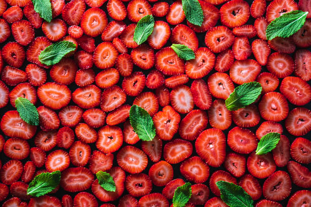 istock Strawberry pattern texture, cut strawberries berries and mint leaves background 1328324104