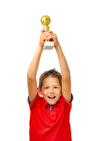 Boy athlete winner rejoices at victory and raises the cup up.