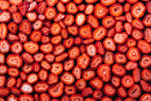 Strawberry pattern texture, cut strawberries berries background full frame slices