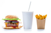 Burger combo cheeseburger Take away beverage glass and french fries in kraft box isolated on white