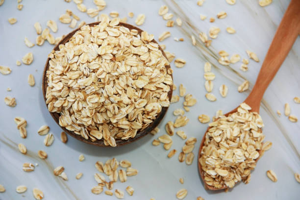 istock dry oat flakes in a wooden spoon 1328325334