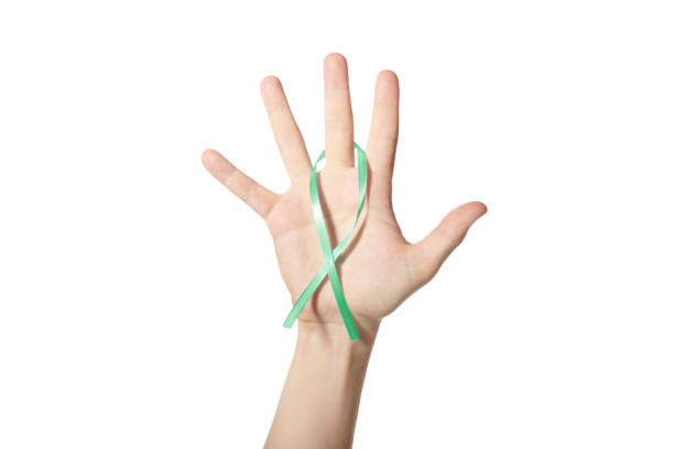 istock Green awareness ribbon in hand 1328327426