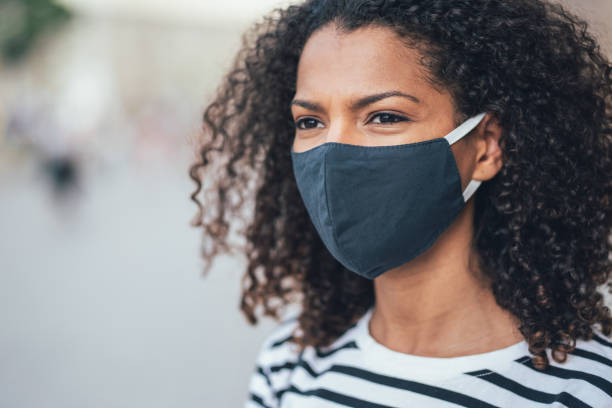 istock Woman with face protective mask 1328327517