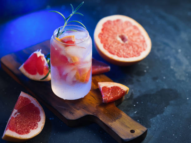 istock Trendy creative ice cocktail-lemonade with grapefruit and tonic. Summer refreshing drink, blue backlight 1328331678