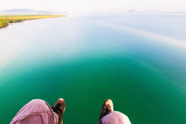 Flying over the sea on a paraglider. Freedom, exploration, extreme, travel, recreation concepts.