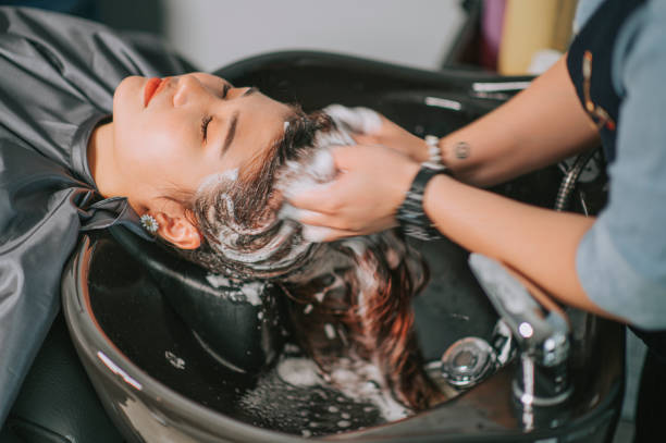 Directly above Asian chinese female lying down for hair wash at hair salon with eyes closed Directly above Asian chinese female lying down for hair wash at hair salon with eyes closed hairdresser stock pictures, royalty-free photos & images