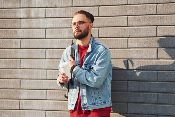 istock Handsome young guy in casual clothes is outdoors at sunny daytime 1328333413
