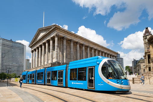 Birmingham, England - 08 July 2021: A blue West Midlands Metro tram at in front of Town Hall in Victoria Square, Birmingham, England, UK.