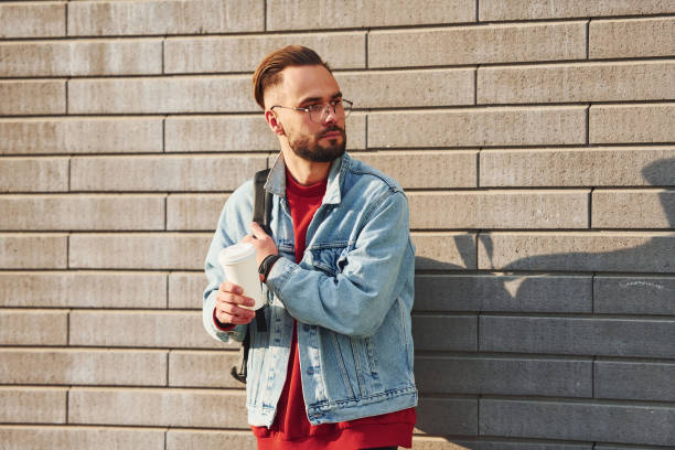istock Handsome young guy in casual clothes is outdoors at sunny daytime 1328334370