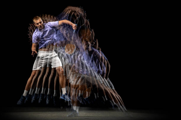 istock One young male badminton player, shuttler training isolated on dark background. Stroboscope effect. 1328336392