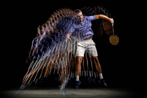istock One young male badminton player, shuttler training isolated on dark background. Stroboscope effect. 1328336399