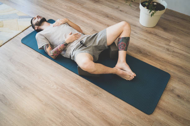 istock Young man doing diaphragmatic breathing exercise for deep relaxation 1328338223