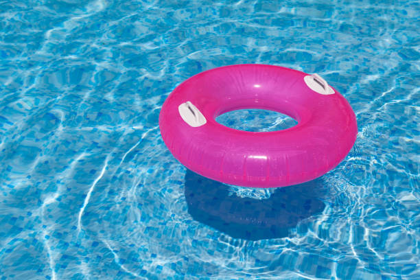 istock Inflatable ring in the pool through water casts shadow on blue mosaic tiles. Distortion. Refraction. Concept - Summer vacation. 1328339133