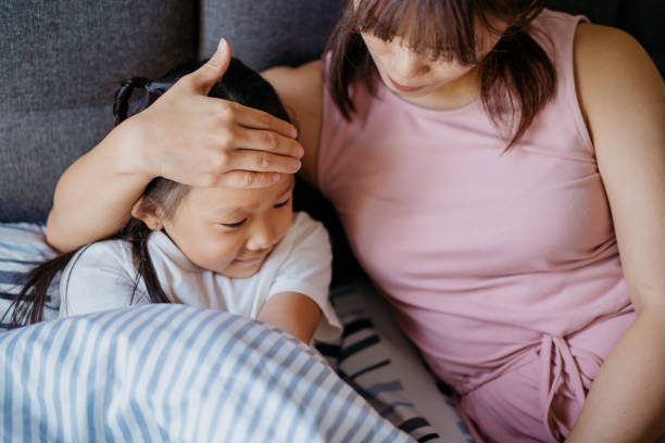 istock Mother touching forehead of her daughter 1328339547