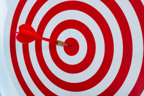 istock Dart arrow on center of dartboard 1328339614