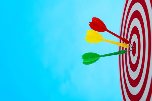 istock Dart arrows on center of dartboard 1328339616