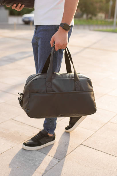 istock Unrecognizable man walks around the city holding bag in his hand 1328339621