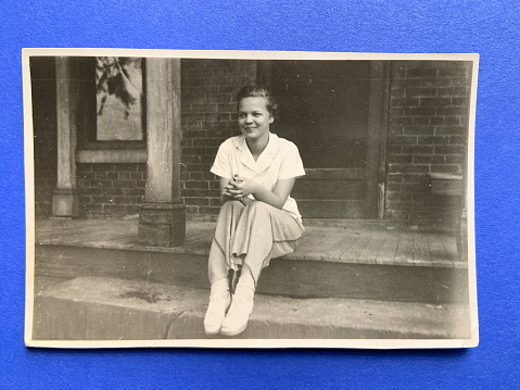 Young woman 1930s sitting on steps