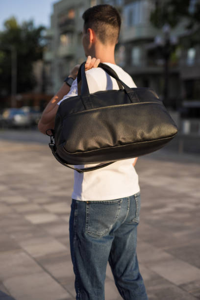 istock A man walks around a city holding bag on his shoulder 1328339773