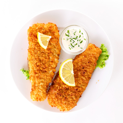 breaded fish with dipping sauce and lemon