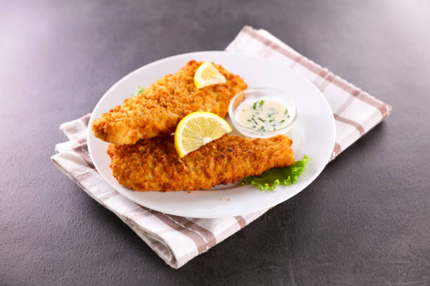 istock breaded fish with dipping sauce and lemon 1328339822