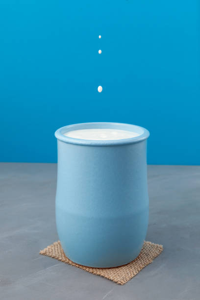 istock Turkish drink Ayran or kefir in light blue ceramic jug on blue background. Fermented milk drink. Diet drink for weight loss. Buttermilk from yogurt. Selective focus, vertical orientation, copy space 1328340887