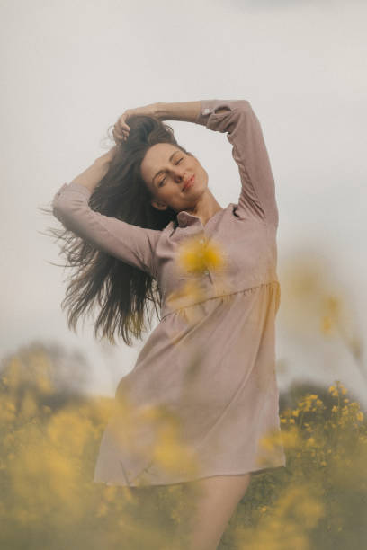 istock Happy young woman in rape field 1328340901