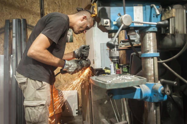 istock Craftsman with electric grinder tool on steel structure in factory 1328340926