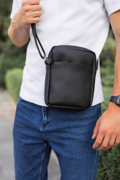 istock Closeup man holding a messenger bag 1328341439