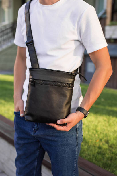 istock Closeup man holding a messenger bag 1328341887