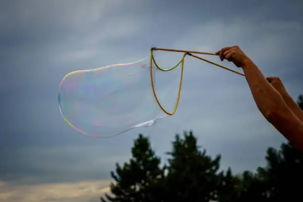 Photo of Releasing huge colorful soap bubbles in the open air