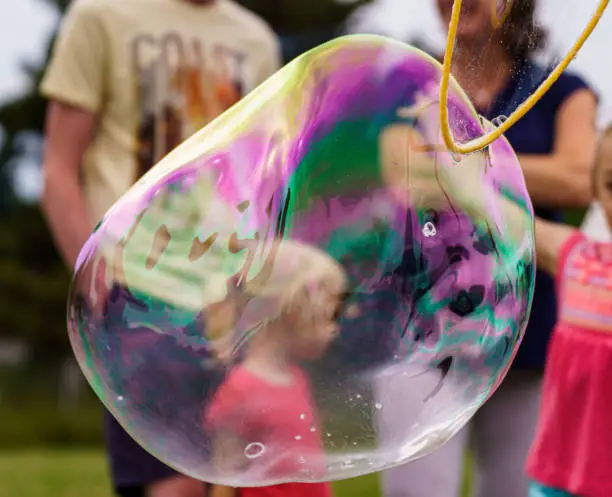 Photo of Releasing huge colorful soap bubbles in the open air