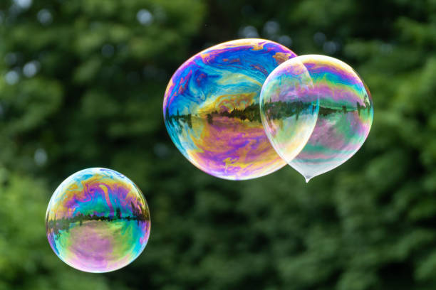 Releasing huge colorful soap bubbles in the open air stock photo
