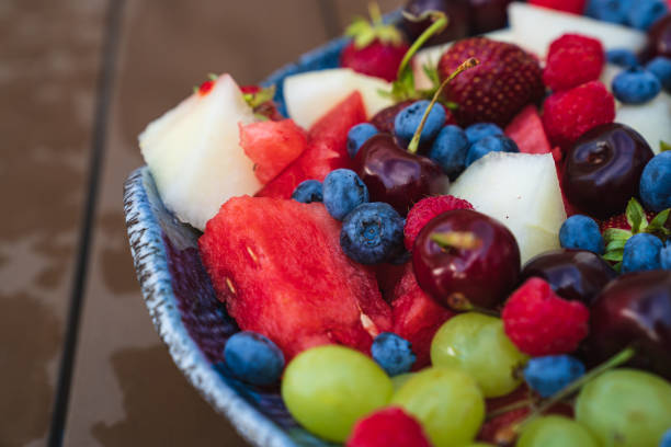 assorted fruits and berries on a plate. summer harvest. cherries, blueberries, raspberries, strawberries, grapes, melon and watermelon. natural, delicious and healthy dessert. Vitamins.