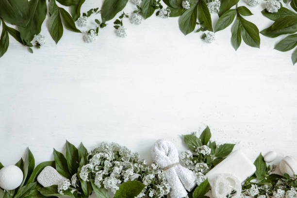 istock Spa composition with fresh flowers and body care products copy space. 1328343961