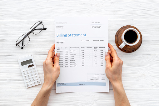 Accounting medical billing statement with calculator.