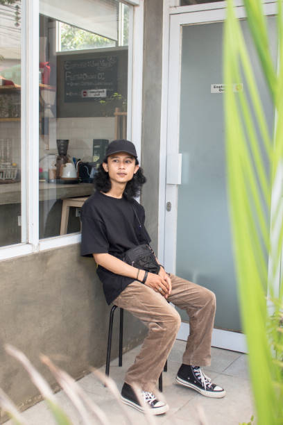 istock Young men sitting enjoying in an outdoor cafe 1328344574