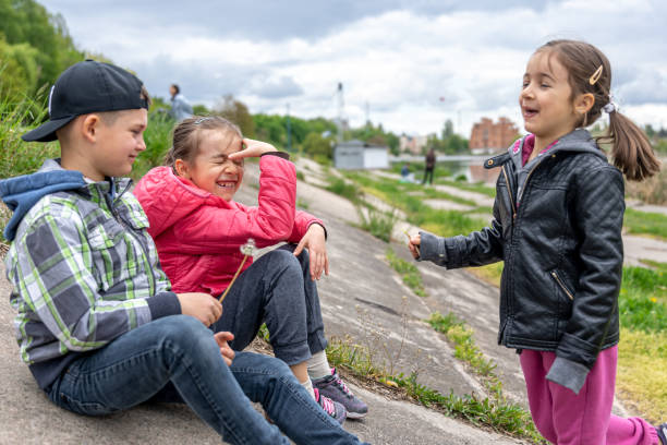 Small children sit and communicate together during a walk.
