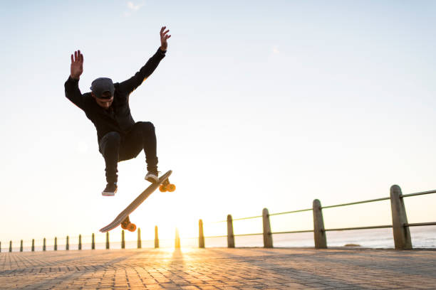 istock Skateboarder in mid-air performing skate trick 1328346117