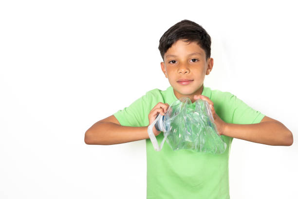 istock Child starting to crush with both hands a plastic bottle for recycling 1328346285