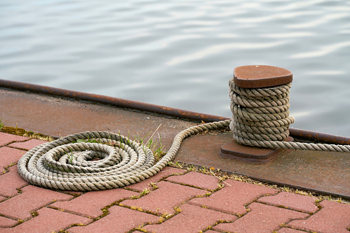 Bollard and mooring rope from a moored ship on the Mittellandkanal near Magdeburg in Germany